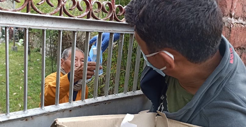 An elderly at Kamrao Gapa Tibetan settlement given a hand sanitizer by a settlement authority. April 17, 2020. Photo-Facebook