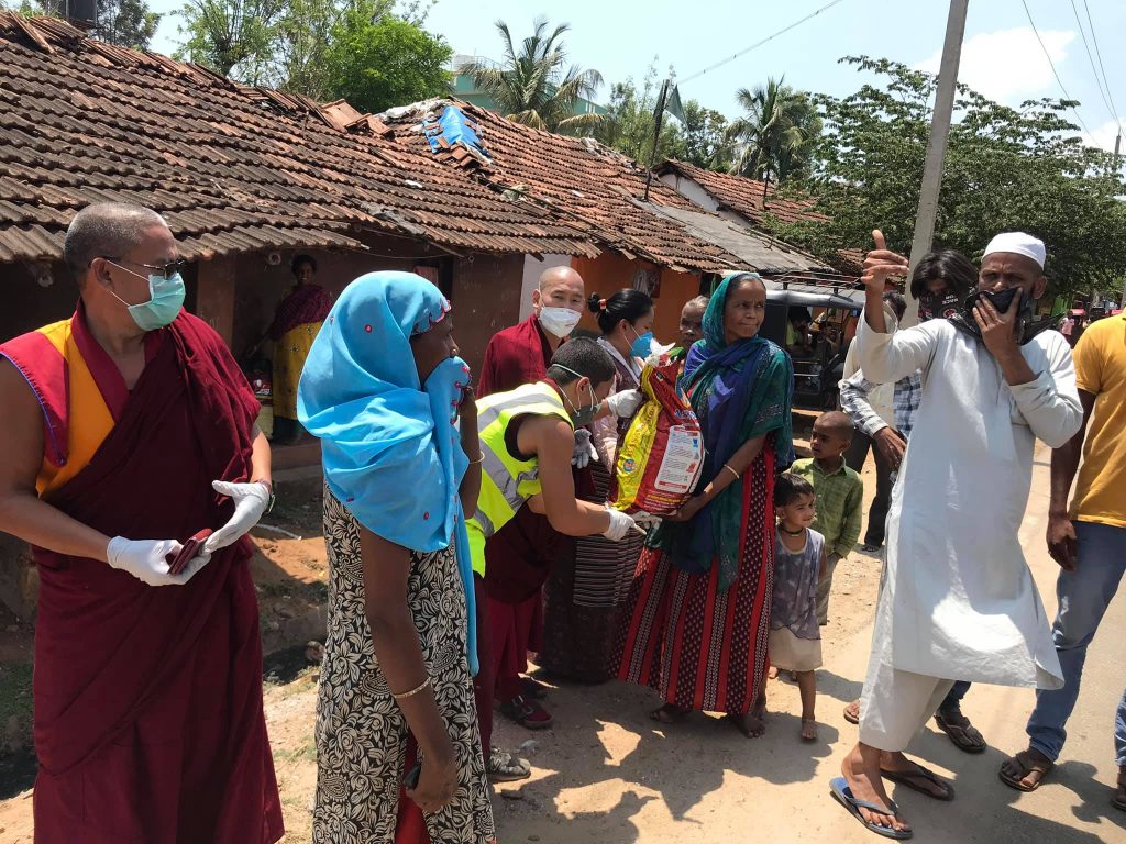 Tashi Lhunpo Abbot seen disttributing ration to locals in Bylakuppe, karnataka. Photo- Tashi Lhunpo Monastery.
